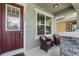 Cozy front porch with seating and a decorative door at 16274 Taliesin St, Winter Garden, FL 34787