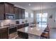 Modern kitchen featuring stainless steel appliances, granite countertops, and an island with seating at 16274 Taliesin St, Winter Garden, FL 34787