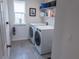 Laundry room featuring a front-load washer and dryer set and wire shelving at 16274 Taliesin St, Winter Garden, FL 34787