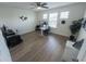 Bright office featuring laminate floors, multiple computer workstations, and a ceiling fan at 16274 Taliesin St, Winter Garden, FL 34787