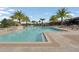 Enjoy the large community pool, surrounded by lounge chairs and shady umbrellas at 16274 Taliesin St, Winter Garden, FL 34787