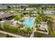 Stunning aerial view of the community pool, with palm trees and a lounging area at 16274 Taliesin St, Winter Garden, FL 34787