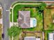 Bird's eye view shows backyard with in-ground pool, patio, play set, and fire pit at 1701 Smoketree Cir, Apopka, FL 32712