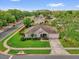 Landscaped home features lush front lawn, mature trees, and long driveway at 1701 Smoketree Cir, Apopka, FL 32712
