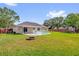 Spacious backyard with in-ground pool, covered patio, privacy fence, and fire pit at 1701 Smoketree Cir, Apopka, FL 32712