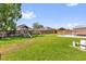 Lush backyard with pool, play set, privacy fence, and covered patio at 1701 Smoketree Cir, Apopka, FL 32712