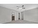 Large bedroom with carpet, neutral paint, and doorways leading to a bathroom and walk-in closet at 1701 Smoketree Cir, Apopka, FL 32712