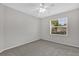Neutral bedroom features a ceiling fan, carpeting, and a window providing natural light at 1701 Smoketree Cir, Apopka, FL 32712