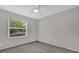 Light filled bedroom with carpet, neutral paint, and a window providing views of the outdoors at 1701 Smoketree Cir, Apopka, FL 32712