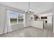 Dining space featuring tile flooring, modern light fixture, and view of the pool area at 1701 Smoketree Cir, Apopka, FL 32712