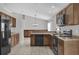 Functional kitchen with tile floors, sleek appliances, wood cabinets, and ample counter space at 1701 Smoketree Cir, Apopka, FL 32712