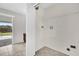 Bright laundry area features tile flooring, utility sink, and slider to backyard at 1701 Smoketree Cir, Apopka, FL 32712
