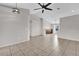 Spacious, neutral living room with tile floors, modern ceiling fan, and plenty of natural light at 1701 Smoketree Cir, Apopka, FL 32712