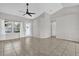 Bright living room showcasing tile flooring, large windows, and a contemporary ceiling fan at 1701 Smoketree Cir, Apopka, FL 32712