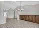 Open-concept living area with tile flooring, built-in cabinetry, and contemporary lighting fixtures at 1701 Smoketree Cir, Apopka, FL 32712