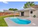 Backyard with in-ground pool, covered patio, and privacy fence at 1701 Smoketree Cir, Apopka, FL 32712