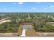 Lovely aerial view of a single-story home surrounded by lush greenery and a bordering tree line at 17787 Sw 22Nd Ave, Ocala, FL 34473