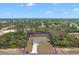 A beautiful aerial view of a single-story home nestled amongst lush greenery and a bordering tree line at 17787 Sw 22Nd Ave, Ocala, FL 34473
