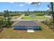Rear aerial view of home with gray roof, concrete patio, and green lawn at 17787 Sw 22Nd Ave, Ocala, FL 34473