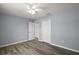 This bedroom has gray walls, hardwood floors, a ceiling fan, and a closet with double doors, providing ample storage at 17787 Sw 22Nd Ave, Ocala, FL 34473