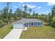 Inviting single-story home featuring a well-manicured lawn and attached two-car garage at 17787 Sw 22Nd Ave, Ocala, FL 34473
