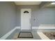 Close up of the home's welcoming front door, featuring modern hardware and a smart doorbell at 17787 Sw 22Nd Ave, Ocala, FL 34473