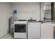 This laundry room includes a washer, a dryer, and a hot water heater at 17787 Sw 22Nd Ave, Ocala, FL 34473