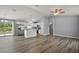 Open-concept kitchen and living space with wood flooring, modern lighting, and island at 17787 Sw 22Nd Ave, Ocala, FL 34473