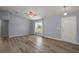 Bright living room with wood-look floors, ceiling fan, and a front door at 17787 Sw 22Nd Ave, Ocala, FL 34473