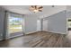 Comfortable living room with wood-look floors, large window and a ceiling fan at 17787 Sw 22Nd Ave, Ocala, FL 34473