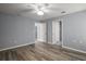 Bedroom with a ceiling fan, gray walls, wood flooring, and ensuite bathroom at 17787 Sw 22Nd Ave, Ocala, FL 34473