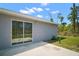 Close-up of the back exterior with a sliding glass door leading to a concrete patio at 17787 Sw 22Nd Ave, Ocala, FL 34473