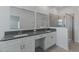 This bathroom features a dual vanity with sinks and a glass enclosed shower at 1908 Blissful Dr, Kissimmee, FL 34744