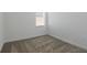 This bedroom features neutral walls, carpet floors, and a window with blinds at 1908 Blissful Dr, Kissimmee, FL 34744