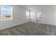 Sunny bedroom featuring neutral carpet, white walls, and windows with blinds at 1908 Blissful Dr, Kissimmee, FL 34744