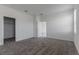 Bright bedroom with neutral carpet, white walls, and walk-in closet at 1908 Blissful Dr, Kissimmee, FL 34744