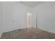 Bright bedroom featuring neutral carpet, white walls, and adjacent rooms at 1908 Blissful Dr, Kissimmee, FL 34744
