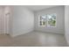 Neutral bedroom featuring light tile flooring, white walls, and two windows with blinds at 1908 Blissful Dr, Kissimmee, FL 34744