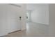 Inviting entryway with white front door, light tile flooring, and view into adjacent room at 1908 Blissful Dr, Kissimmee, FL 34744