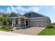 Well-maintained home with a two-car garage, a beautiful lawn, and a durable brick driveway at 1908 Blissful Dr, Kissimmee, FL 34744