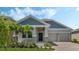 Charming single-Gathering home featuring a two-car garage, manicured lawn, and tasteful stone accents at 1908 Blissful Dr, Kissimmee, FL 34744