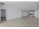 Spacious living room featuring tile flooring and an open floor plan with access to the kitchen at 1908 Blissful Dr, Kissimmee, FL 34744