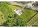 An aerial view of a large green lot with a house and a shed at 1981 N County Road 426, Oviedo, FL 32765