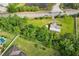 An aerial view of a home surrounded by trees and a road nearby at 1981 N County Road 426, Oviedo, FL 32765