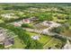 Aerial perspective of commercial buildings, pond, and neighborhood with easy road access at 1981 N County Road 426, Oviedo, FL 32765