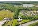 An aerial view of a home nestled near a lake and wooded area at 1981 N County Road 426, Oviedo, FL 32765