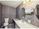 The bathroom features grey walls, a toilet, and a sink with mirror at 1981 N County Road 426, Oviedo, FL 32765