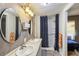 The bathroom features double sinks, oval mirrors, and a shower with curtain at 1981 N County Road 426, Oviedo, FL 32765