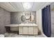 Bathroom features a double sink vanity, oval mirrors, and a blue shower curtain at 1981 N County Road 426, Oviedo, FL 32765