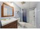 Bathroom with a single vanity, toilet and a shower with blue pattern curtain at 1981 N County Road 426, Oviedo, FL 32765